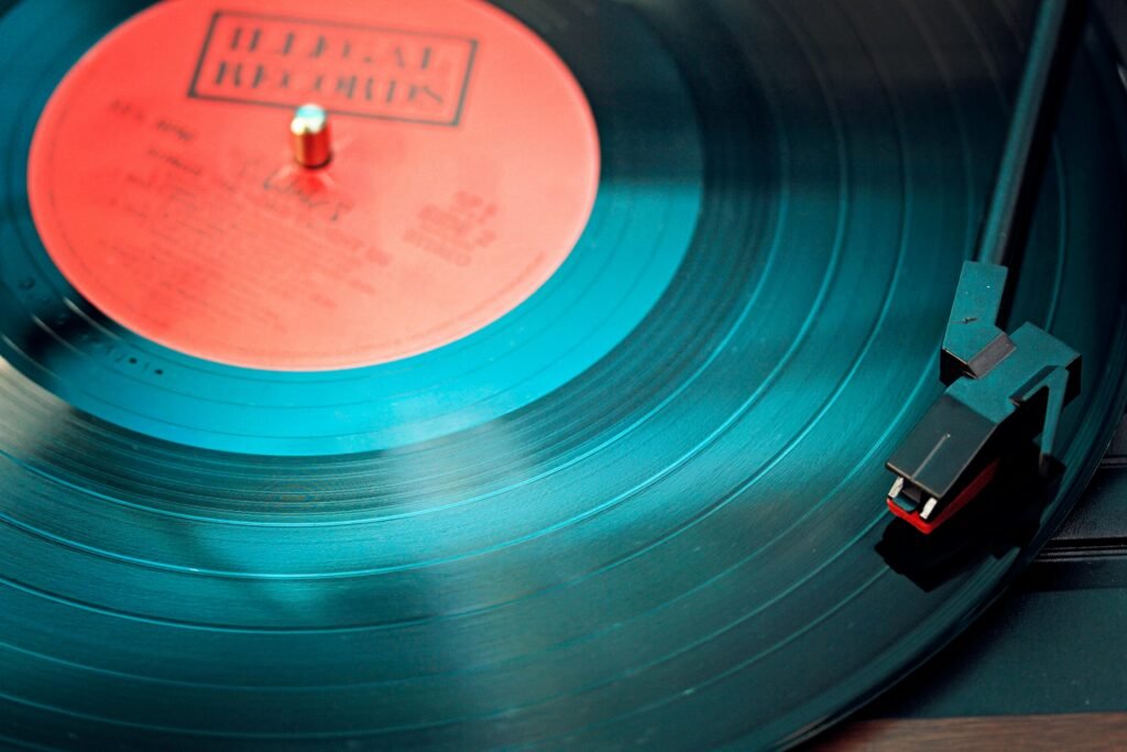 pexels-photo-1389429-1389429-1 A detailed close-up view of a vintage vinyl record spinning on a turntable, capturing its nostalgic beauty.